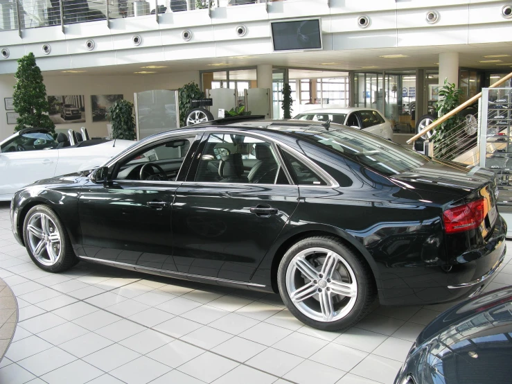 black car parked in front of building next to balconies