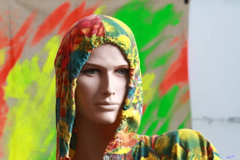 the woman is dressed in a colorful head covering