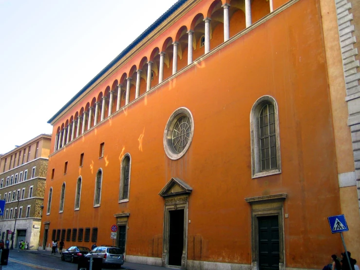 an orange building in the middle of the street