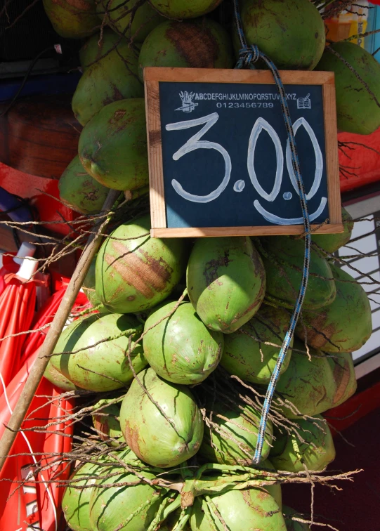 a small sign for the price of coconuts is on display