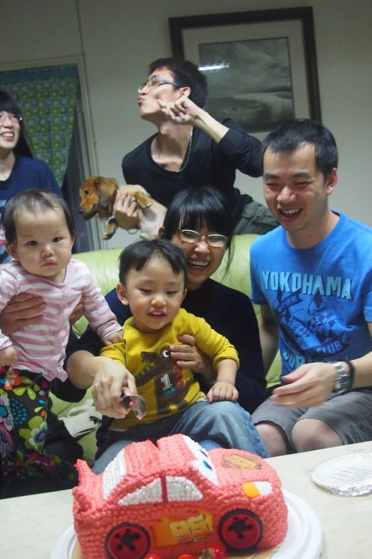 the family is sitting together and celeting their baby's first birthday