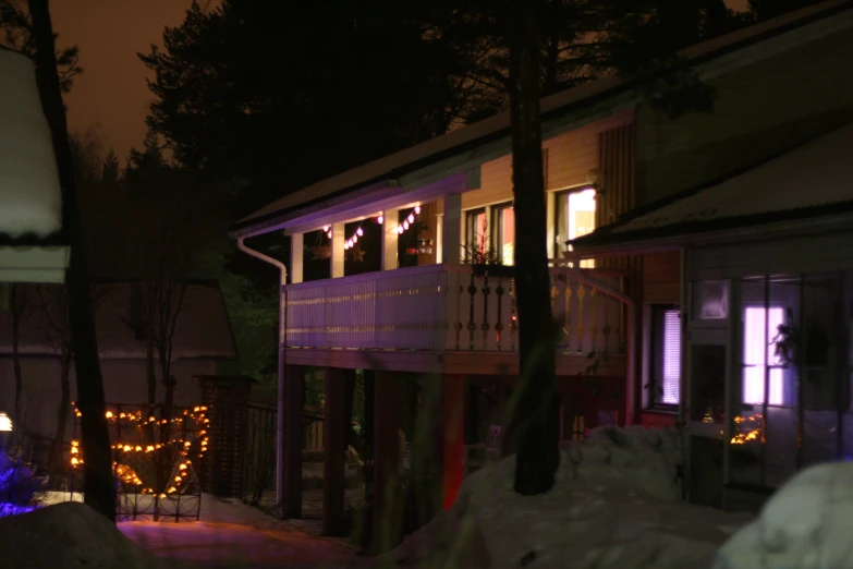 christmas lights at night outside of an upper floor apartment building