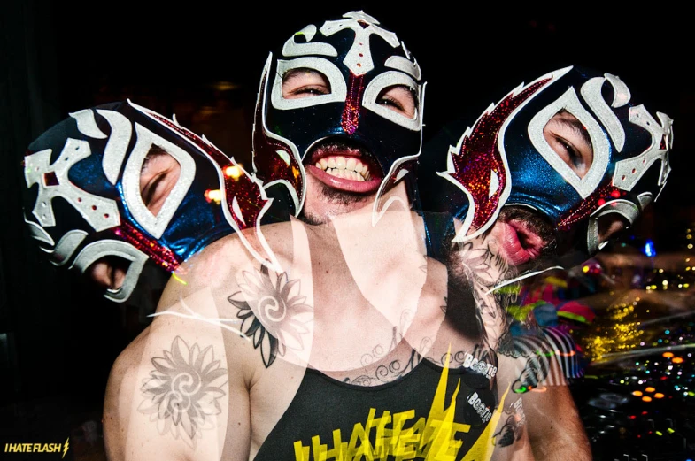 a man with tattoos and a mask and body paint