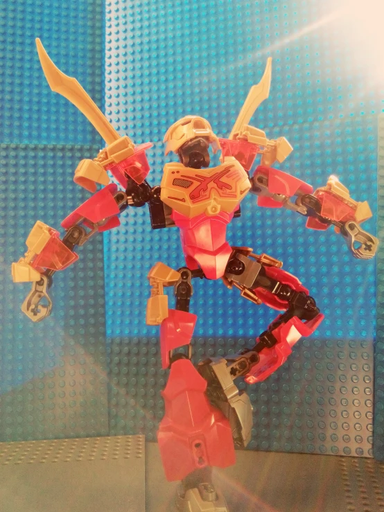 a plastic figurine of a robot fighter