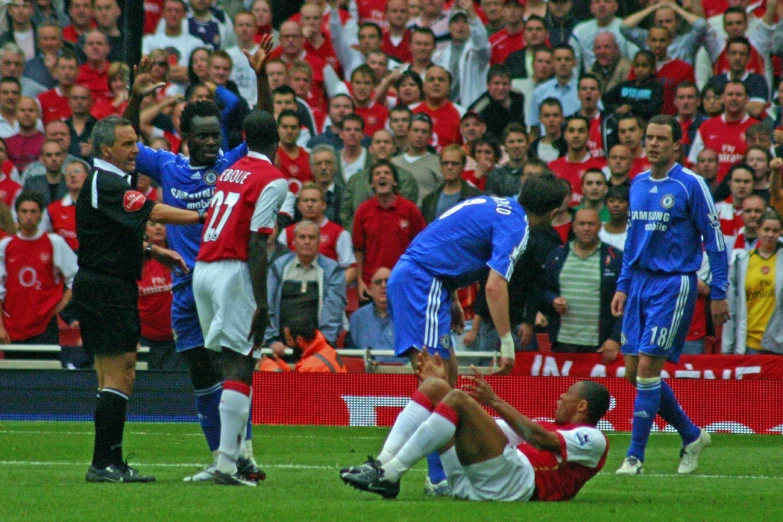 a crowd is watching a soccer game in progress