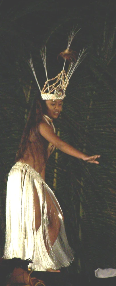 a woman with a straw hat dancing in a costume