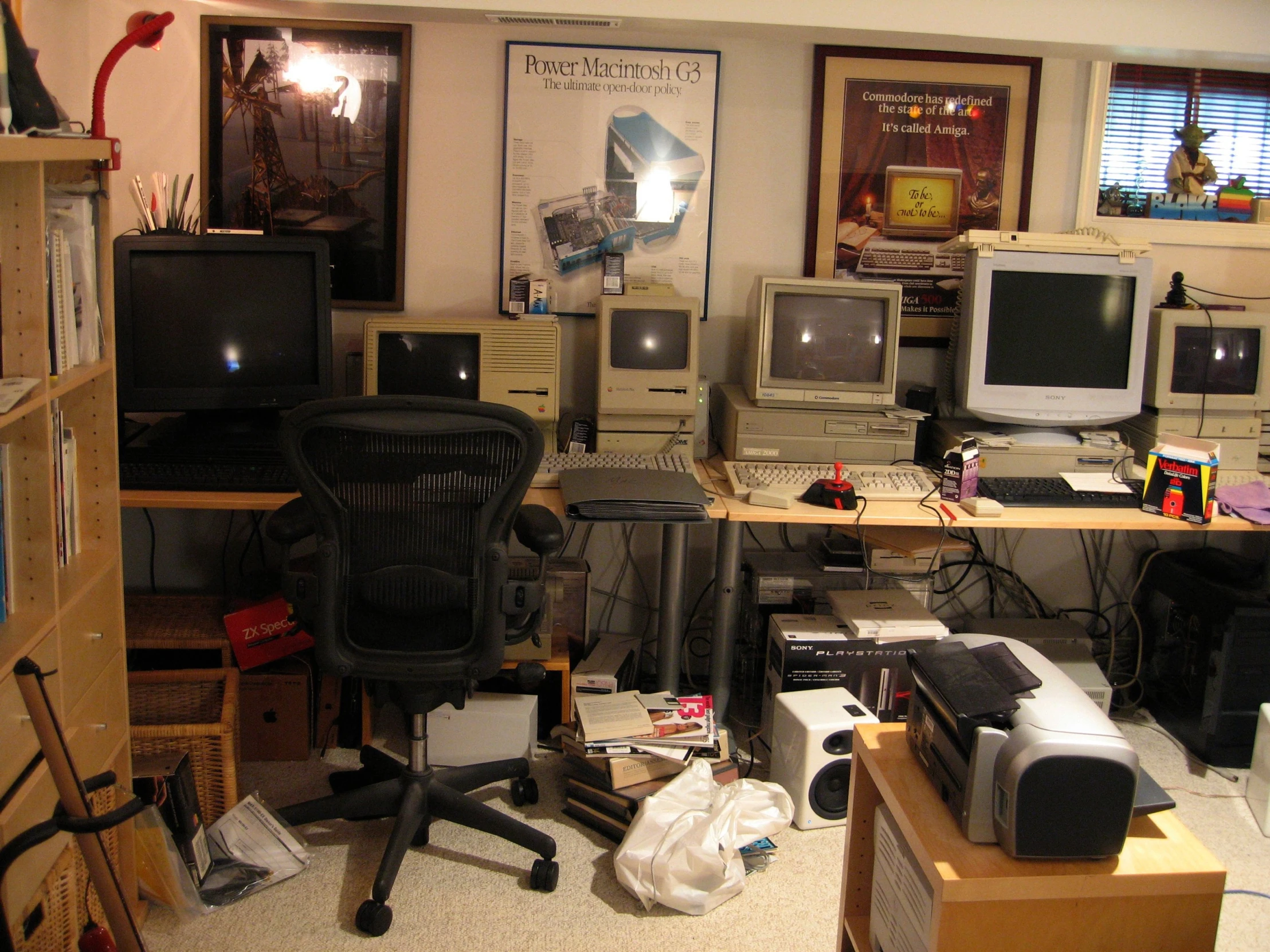 a messy room with multiple computer monitors on desks