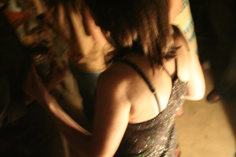 a woman wearing a halter neck top next to another women