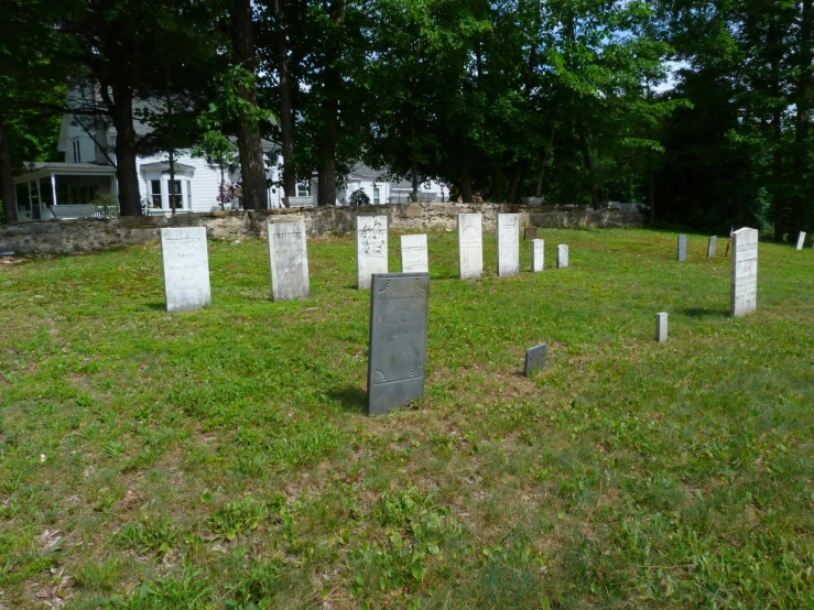 the tombstones are made of stone on a lawn