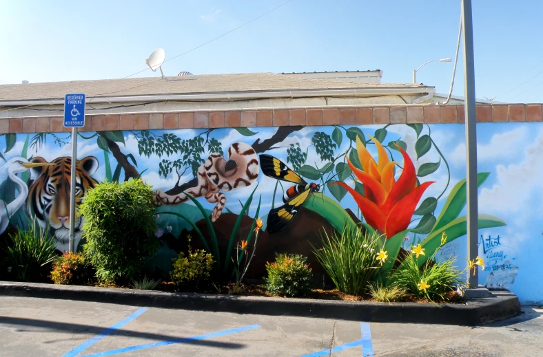 a large painted mural of tigers and plants on a wall