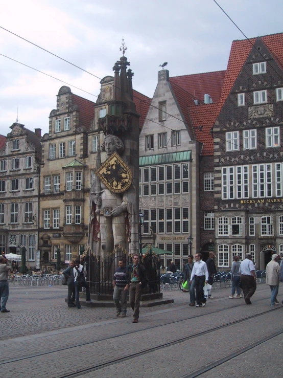 several people in front of an elaborate statue