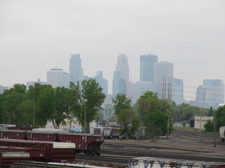 train cars are parked with the skyline in the background