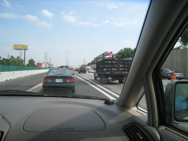 a group of cars driving down the highway