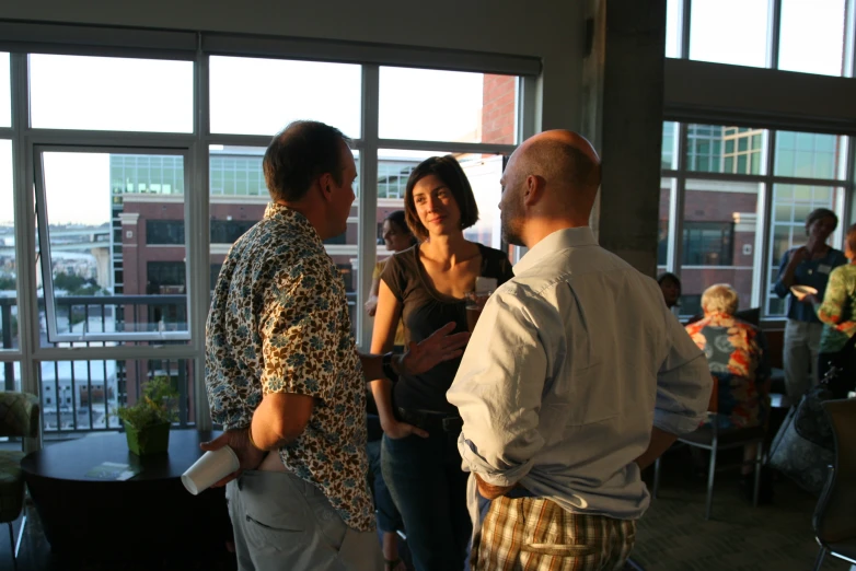 a group of people standing around near large windows