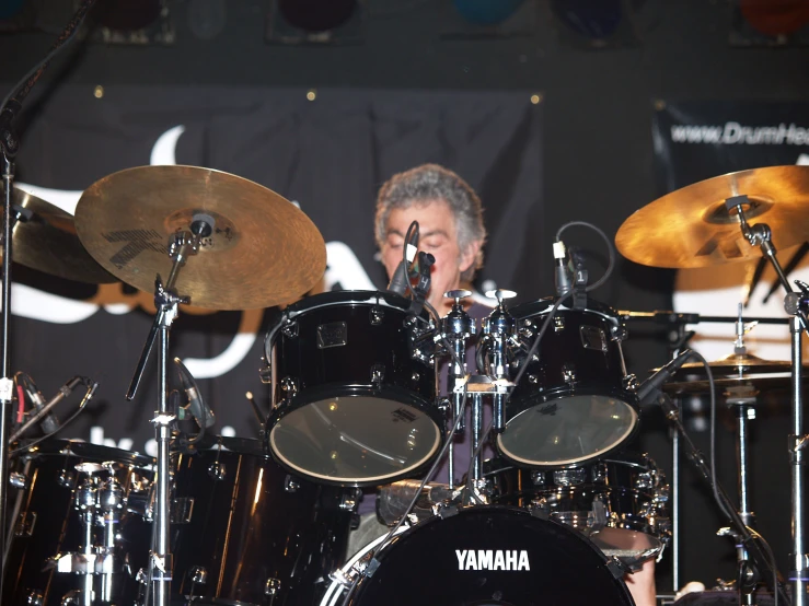 a man is sitting in front of his drums