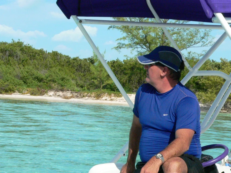 a man sitting on a small boat in the water