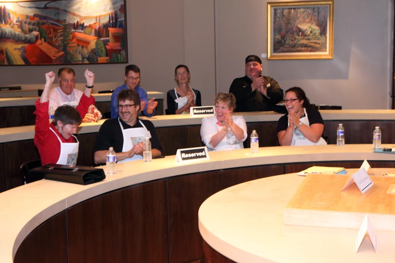 a large group of people sitting in a room together