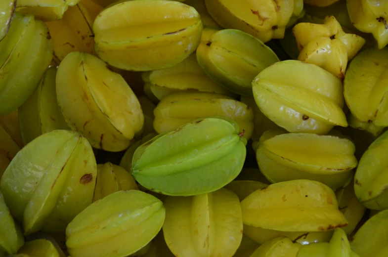 a pile of bananas that have green seeds on them