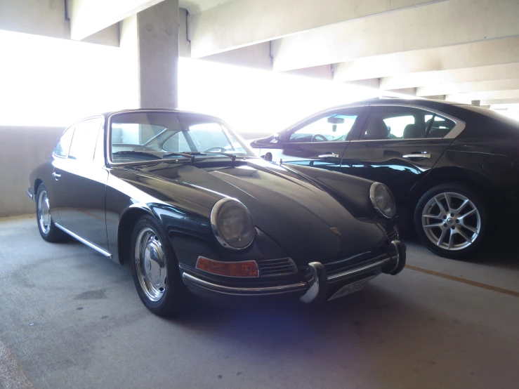 two porsches are sitting parked next to each other