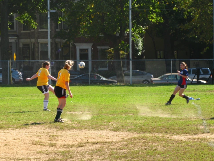 a group of young people kicking around a soccer ball