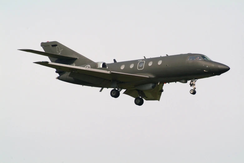 an airplane flying in the sky with its wheels out