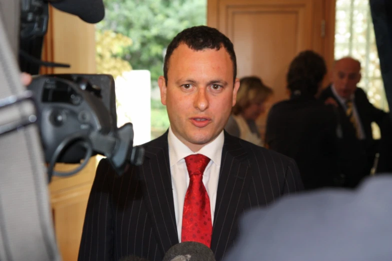 a man wearing a suit and red tie