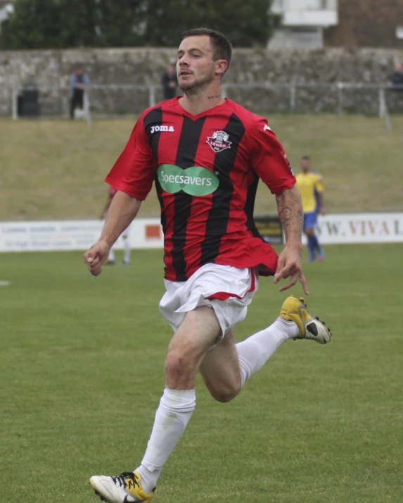 a soccer player kicking the ball around a field