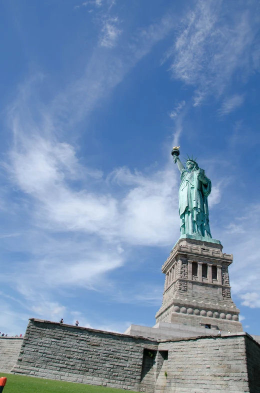 the statue of liberty stands out against the blue sky