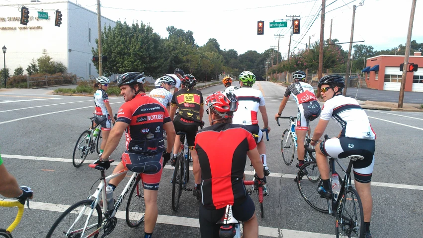 people on bicycle are looking down at the street