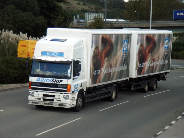 a large truck on a road near buildings