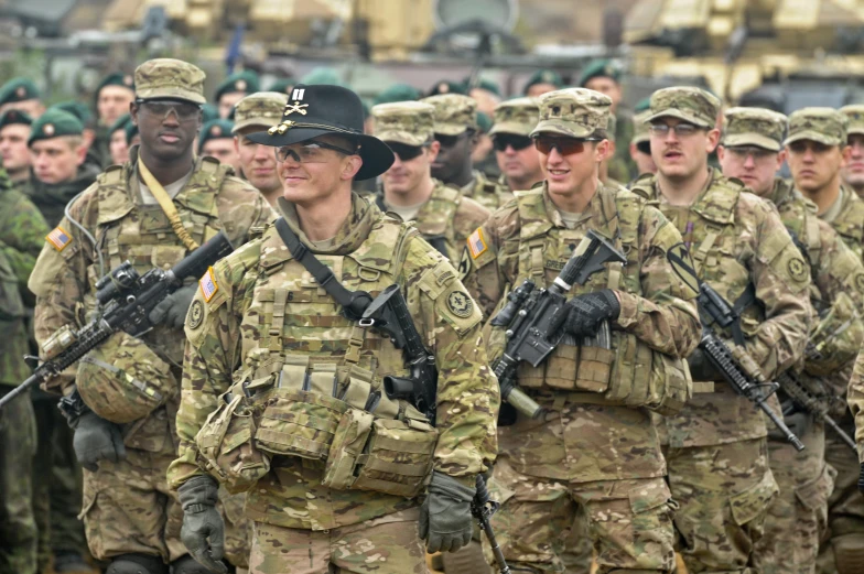 soldiers are marching in a formation in the rain