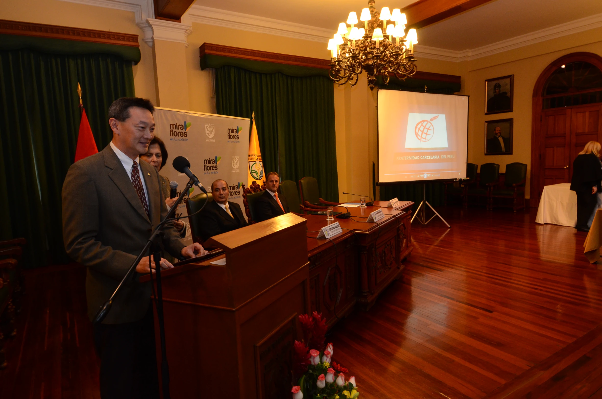 a man is talking at a podium