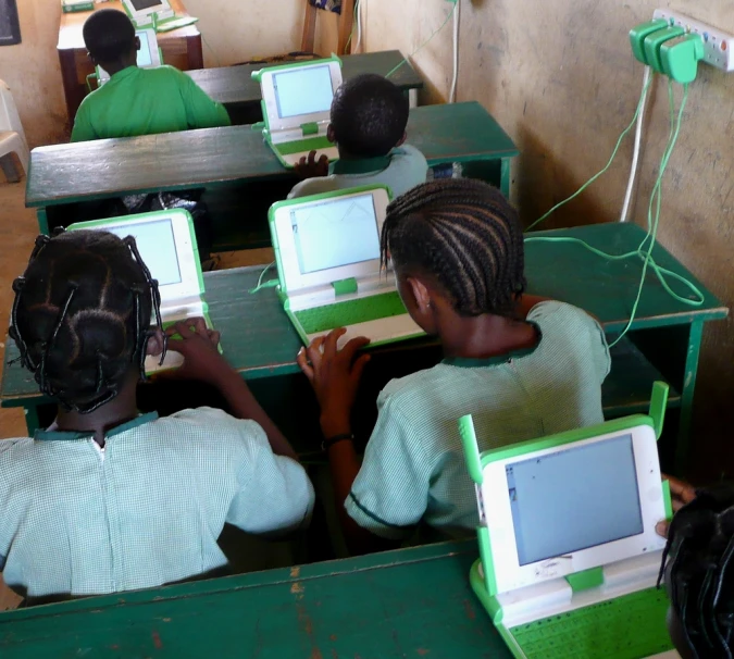 a pair of children using small electronic monitors