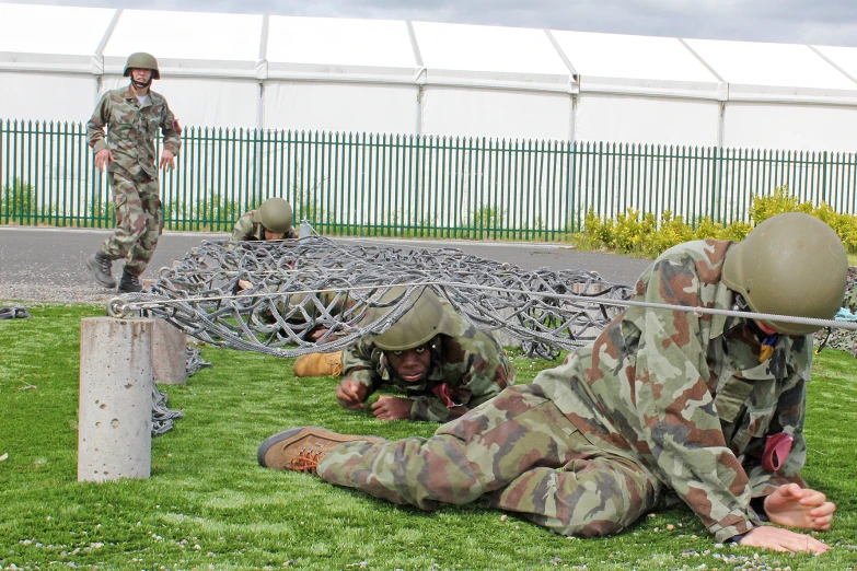 the men are in camouflage playing with their toys