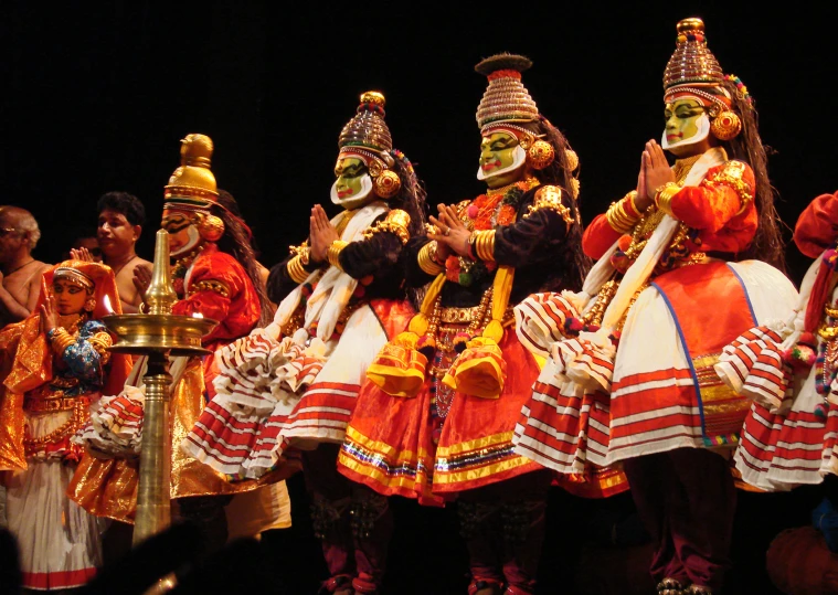 a group of people dressed in costume on stage