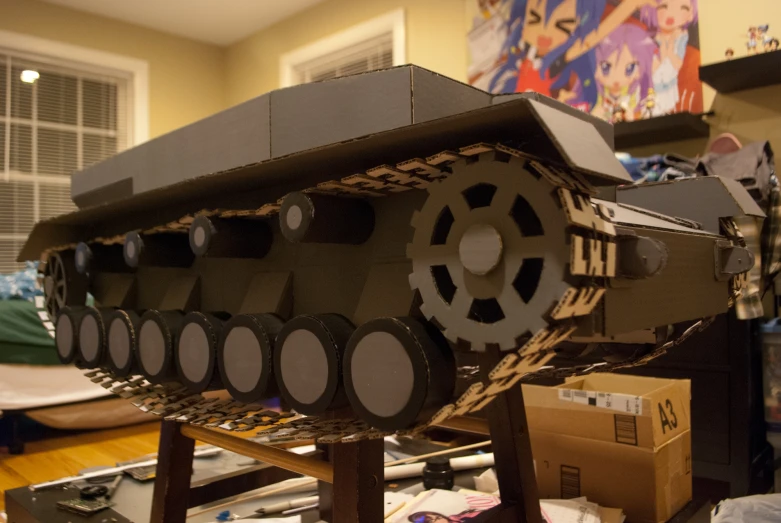 a model tank sitting on top of a wooden table