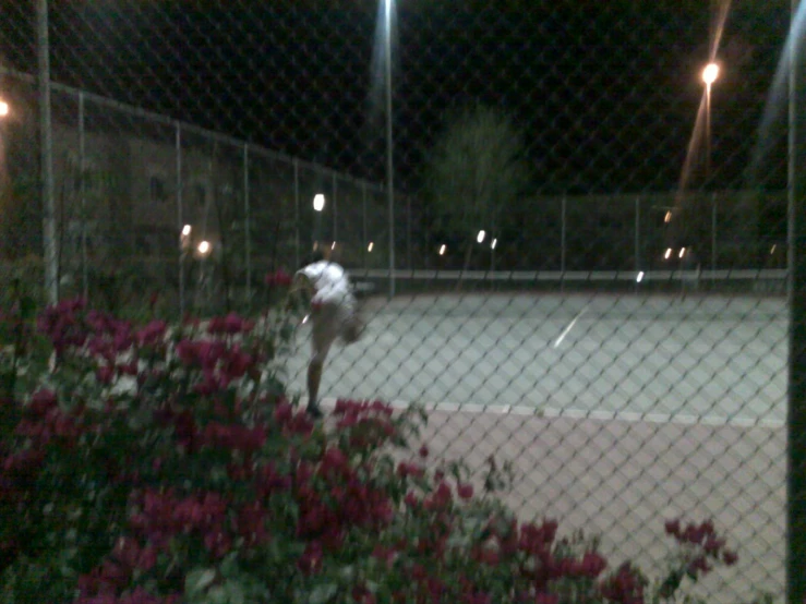 a person jumping to hit a tennis ball with their racket