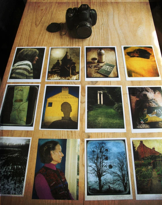 a wooden table topped with pictures of people