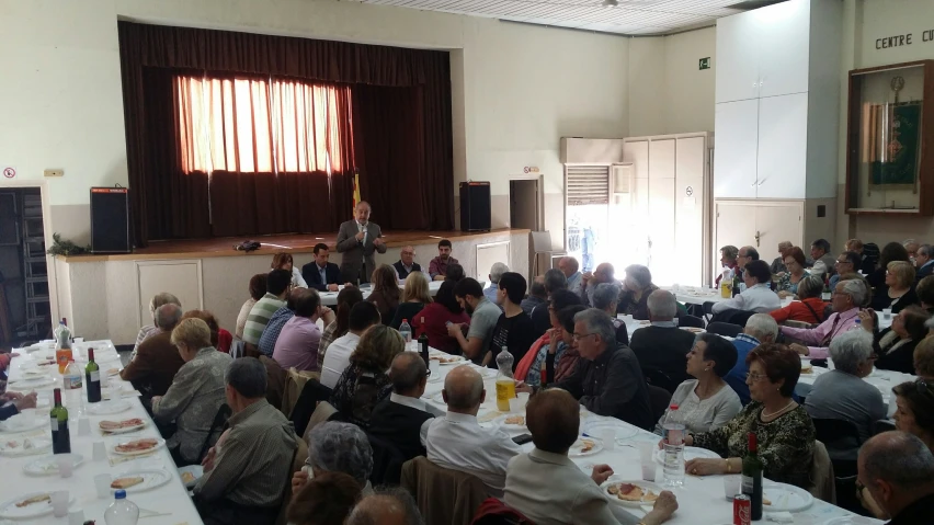 a number of people seated at tables and chairs