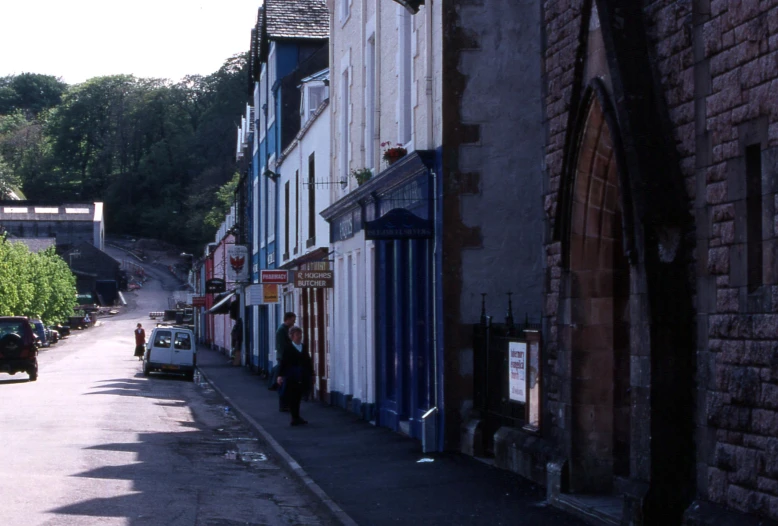 cars parked along a bricked street on both sides