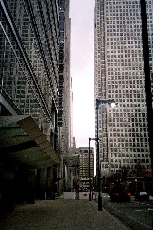 two tall buildings that have a street lamp near them