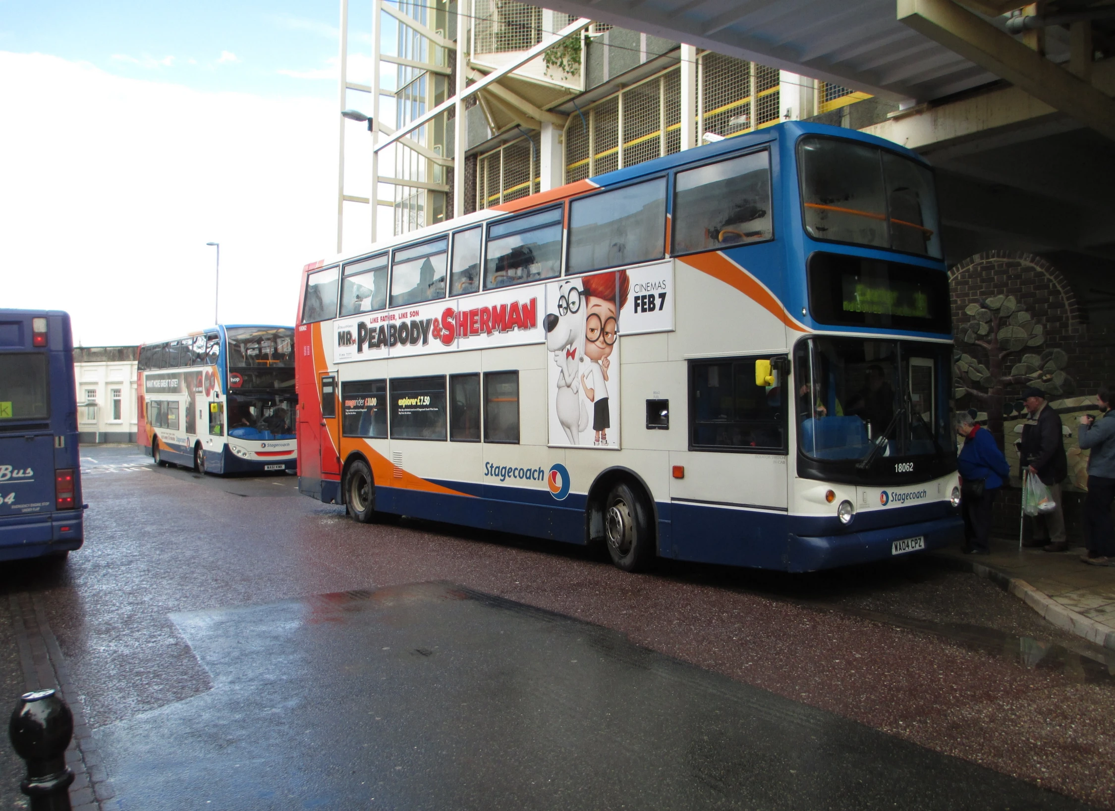 three double decker buses waiting to take people on the road