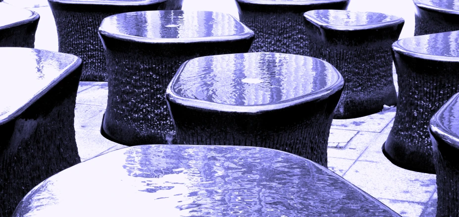 a black and white pograph of many tables outside