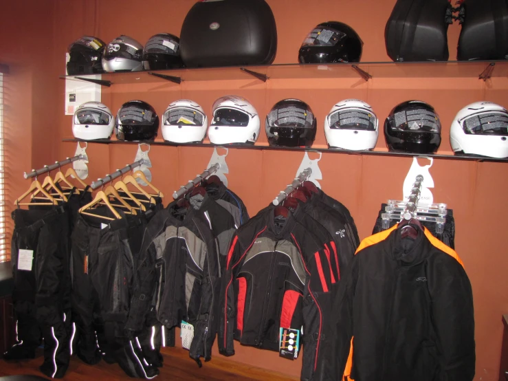 a rack that is holding helmets and jackets