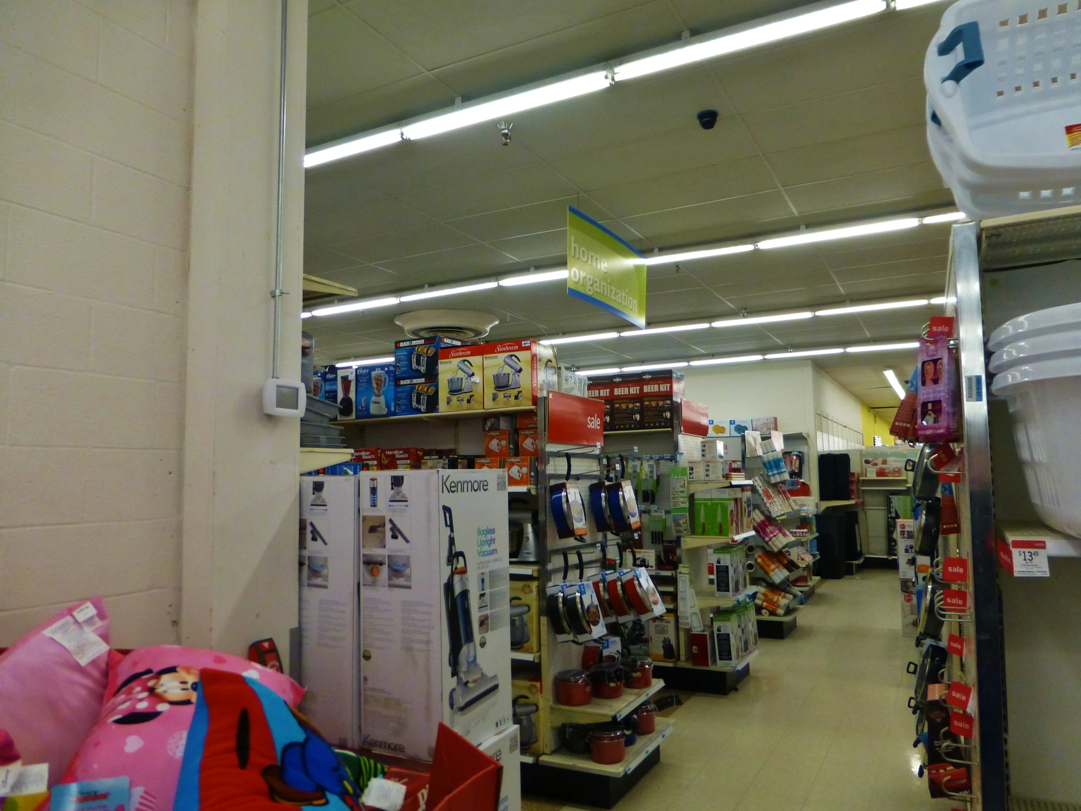 view from behind the counter looking down the aisle into a store