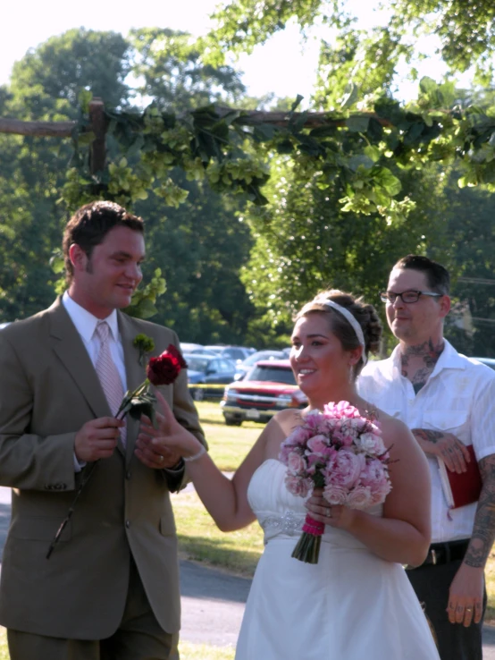a bride and groom with flowers in their hands