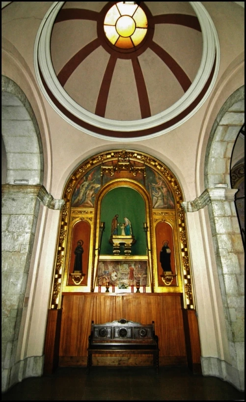 an archway with a window over the back of it and a bench to the side