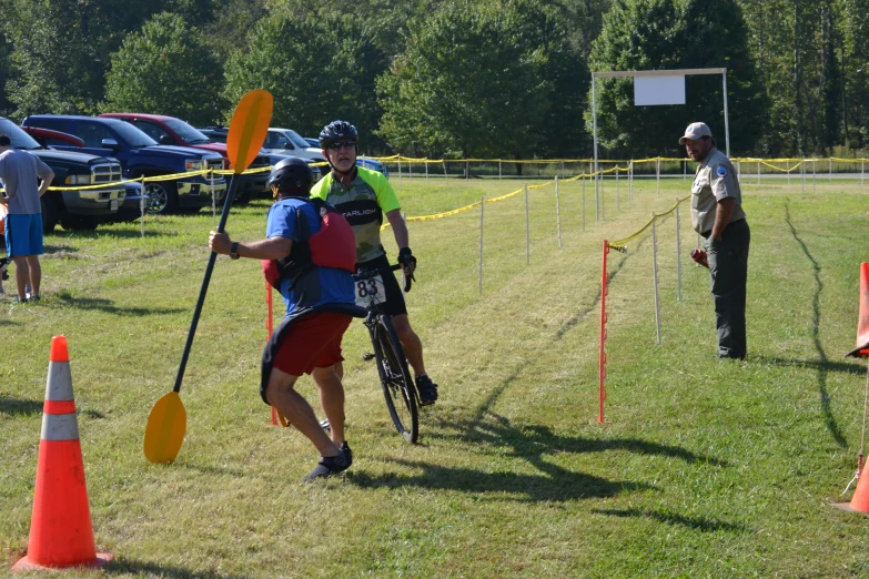 a person on a bike carrying some paddles