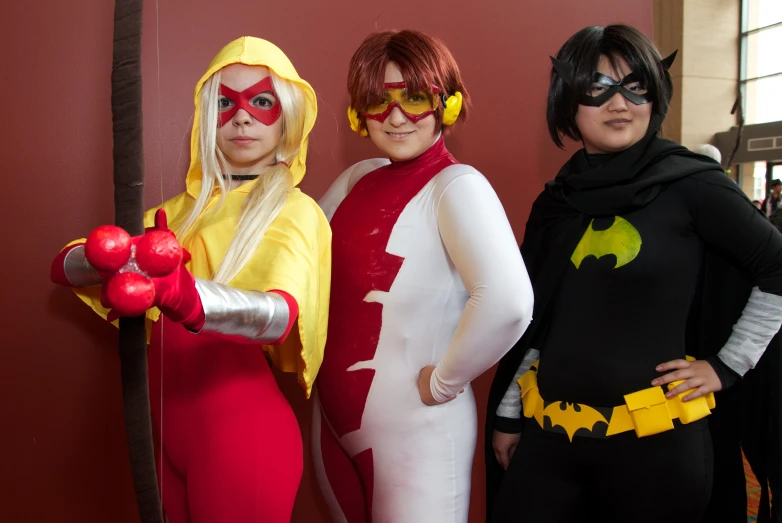 three woman dressed up as batman and harley for halloween