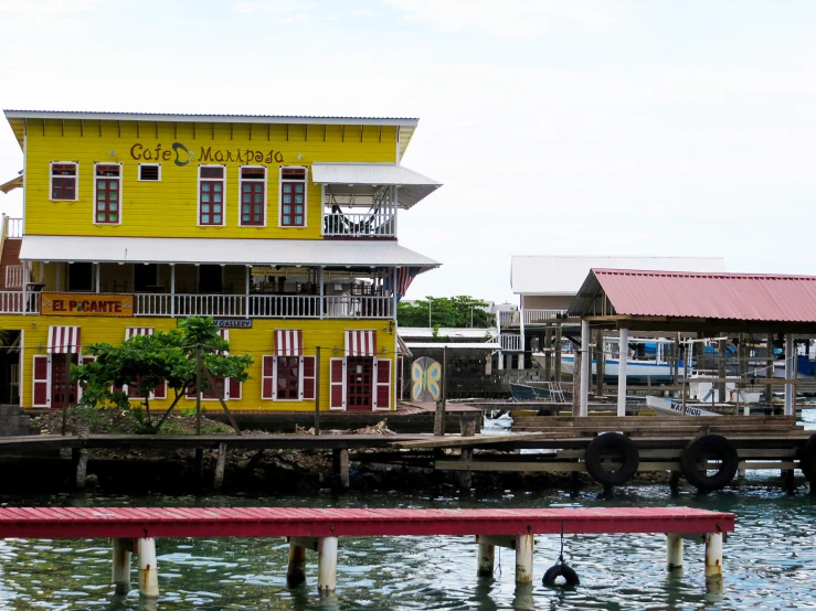 a large yellow house next to a marina